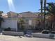 Charming single-story home featuring desert landscaping and a tile roof under a bright blue sky at 7613 Falconwing Ave, Las Vegas, NV 89131