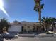 Charming single-story home with desert landscaping, palm trees, and a two-car garage at 7613 Falconwing Ave, Las Vegas, NV 89131