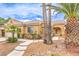 Charming single-story home surrounded by desert landscaping, featuring a tiled roof and a welcoming front entrance at 7613 Falconwing Ave, Las Vegas, NV 89131