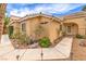 Inviting front exterior with desert landscaping and a walkway leading to the front door, plus lots of greenery at 7613 Falconwing Ave, Las Vegas, NV 89131