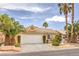 Attractive single-story house features desert landscaping, a two-car garage, and mature palm trees in the front yard at 7613 Falconwing Ave, Las Vegas, NV 89131