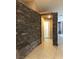 Hallway featuring a stone accent wall and tile flooring at 7613 Falconwing Ave, Las Vegas, NV 89131
