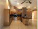Spacious kitchen with wooden cabinets, stainless steel appliances, and an island at 7613 Falconwing Ave, Las Vegas, NV 89131