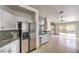 Bright kitchen featuring stainless steel refrigerator, granite counters, and white cabinets at 7613 Falconwing Ave, Las Vegas, NV 89131