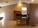 Bright kitchen featuring tile flooring, wooden cabinets, and an island at 7613 Falconwing Ave, Las Vegas, NV 89131