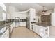 Bright open kitchen features granite counters, stainless appliances, and ample storage at 7613 Falconwing Ave, Las Vegas, NV 89131