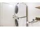 Conveniently stacked washer and dryer set in a dedicated laundry area, ensuring efficiency and space-saving at 7613 Falconwing Ave, Las Vegas, NV 89131
