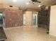 Open living area with tile flooring, stone accent wall, and recessed lighting at 7613 Falconwing Ave, Las Vegas, NV 89131