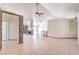Spacious open-plan living area with tile floors, and a unique decorative fireplace in a home with neutral decor at 7613 Falconwing Ave, Las Vegas, NV 89131