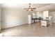 Large living area open to the kitchen with tile flooring and modern ceiling fan at 7613 Falconwing Ave, Las Vegas, NV 89131
