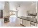 Open-concept living space with tile floors, fireplace, and sliding door access to patio at 7613 Falconwing Ave, Las Vegas, NV 89131