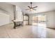 Bright living room with fireplace, fan, and sliding glass doors to outdoor area at 7613 Falconwing Ave, Las Vegas, NV 89131