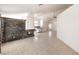 Spacious living room featuring a stone fireplace and neutral tile flooring at 7613 Falconwing Ave, Las Vegas, NV 89131