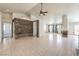 Bright and airy open-concept living area with tile flooring, ceiling fan, fireplace, and recessed lighting at 7613 Falconwing Ave, Las Vegas, NV 89131
