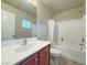 Clean bathroom with a single sink vanity, full-size mirror, and a combined tub and shower at 7735 Pista Way, Las Vegas, NV 89179