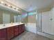 Bathroom showcasing double sinks, a soaking tub, and a glass-enclosed shower at 7735 Pista Way, Las Vegas, NV 89179