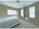 Neutral bedroom boasting natural light from multiple windows and carpeted flooring, ready for customization at 7735 Pista Way, Las Vegas, NV 89179