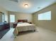 Spacious bedroom with carpet floors, a queen bed, dresser and two windows at 7735 Pista Way, Las Vegas, NV 89179