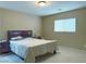 Comfortable bedroom featuring carpet floors, a queen bed, nightstand, and a window at 7735 Pista Way, Las Vegas, NV 89179