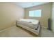 Modest bedroom featuring carpeted floors, a window for natural light, and neutral paint for a cozy feel at 7735 Pista Way, Las Vegas, NV 89179