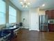 Bright dining area with a modern chandelier, and stainless steel refrigerator at 7735 Pista Way, Las Vegas, NV 89179