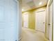 Hallway with neutral carpet featuring multiple white doors and overhead lighting at 7735 Pista Way, Las Vegas, NV 89179
