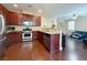 Well-equipped kitchen with dark wood cabinets, granite countertops, and stainless steel appliances at 7735 Pista Way, Las Vegas, NV 89179