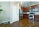 Spacious kitchen with stainless steel appliances, wood cabinets, and tile floors at 7735 Pista Way, Las Vegas, NV 89179