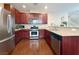 Well-equipped kitchen featuring stainless steel appliances, granite countertops, and wood cabinets at 7735 Pista Way, Las Vegas, NV 89179