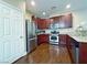 Modern kitchen featuring stainless steel appliances, wood cabinets, and tile floors at 7735 Pista Way, Las Vegas, NV 89179
