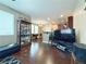 Open-concept living space with hardwood floors connecting the living room, dining area, and kitchen at 7735 Pista Way, Las Vegas, NV 89179