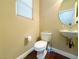 Compact powder room featuring a wall-mounted sink, and wood floors at 7735 Pista Way, Las Vegas, NV 89179