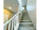 Carpeted stairway with white railing leading to the upper level of the home at 7735 Pista Way, Las Vegas, NV 89179