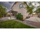 Inviting backyard with covered patio, green lawn, and paved walkway at 780 Flowing Meadow Dr, Henderson, NV 89014