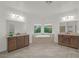 Bright bathroom with and vanities, a soaking tub, and tile floors at 780 Flowing Meadow Dr, Henderson, NV 89014