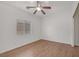 Clean bedroom with light hardwood floors, a ceiling fan, and a window providing natural light at 780 Flowing Meadow Dr, Henderson, NV 89014