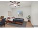 Bedroom features wood look floors, ceiling fan, and natural light from a window at 780 Flowing Meadow Dr, Henderson, NV 89014