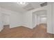 Spacious bedroom with neutral walls, wood floors and arched doorway at 780 Flowing Meadow Dr, Henderson, NV 89014