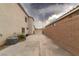Long driveway between houses with a brick wall and beige house at 780 Flowing Meadow Dr, Henderson, NV 89014