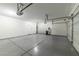 Spacious three-car garage featuring epoxy flooring, ample storage, and an automatic door opener at 780 Flowing Meadow Dr, Henderson, NV 89014