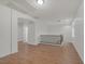 Bright hallway with wood floors, white walls, and arched doorway to other rooms at 780 Flowing Meadow Dr, Henderson, NV 89014
