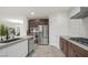 Stylish kitchen featuring a stainless steel refrigerator, double oven, and a center island with bar seating at 780 Flowing Meadow Dr, Henderson, NV 89014