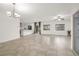 Bright living area with tile flooring, modern lighting fixtures, and direct access to the backyard through sliding doors at 780 Flowing Meadow Dr, Henderson, NV 89014