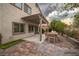 Outdoor patio with pergola, stone pavers, lawn and string lights at 780 Flowing Meadow Dr, Henderson, NV 89014