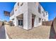Exterior view of the home's backyard with a modern patio, gravel landscaping, and block wall fence at 8629 Ensworth St # 111, Las Vegas, NV 89123