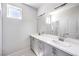 Bathroom featuring double sinks, a large mirror, and modern gray cabinetry at 8629 Ensworth St # 111, Las Vegas, NV 89123