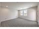 Spacious bedroom with plush carpeting, two windows, and a view of the backyard at 8629 Ensworth St # 111, Las Vegas, NV 89123