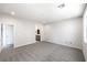 Airy bedroom with soft carpet, a window, and doorway to an ensuite bathroom with gray vanity at 8629 Ensworth St # 111, Las Vegas, NV 89123