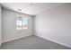 Bright bedroom with soft carpet, white walls, and window with outdoor view at 8629 Ensworth St # 111, Las Vegas, NV 89123