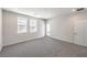 Large, bright bedroom with two windows, carpet flooring, and a door leading to a balcony at 8629 Ensworth St # 111, Las Vegas, NV 89123